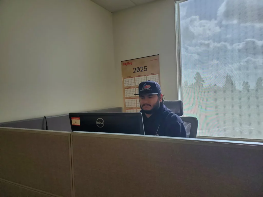 Alinco worker on computer